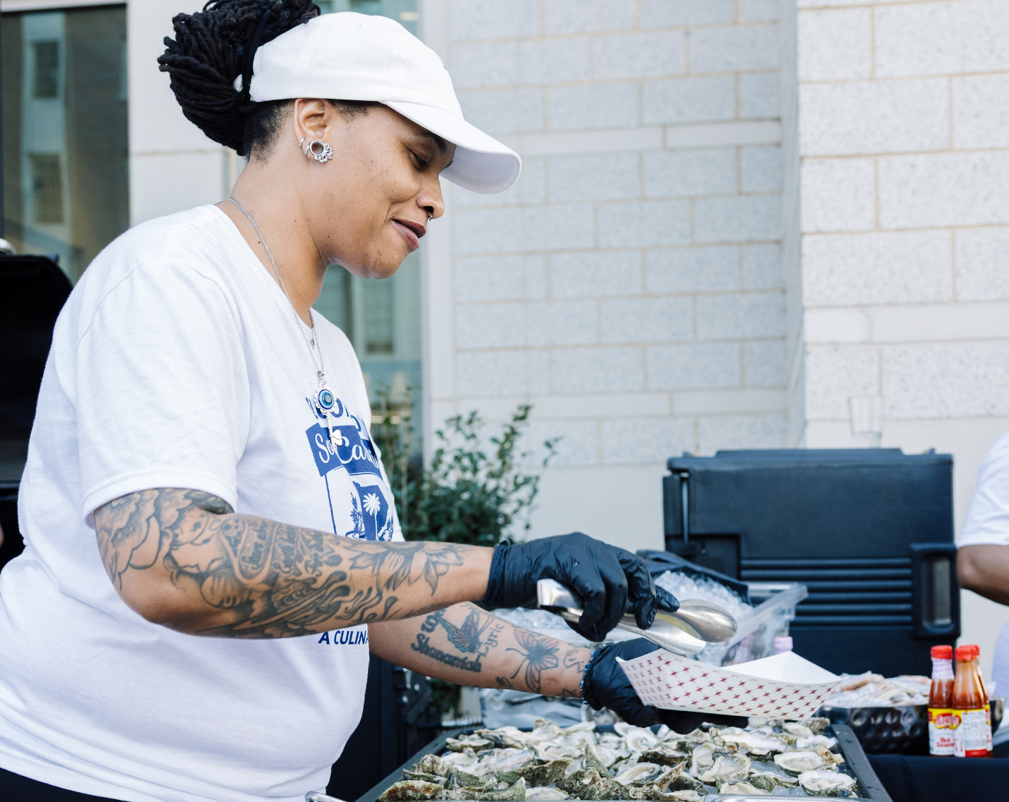 A woman serving oysters. 